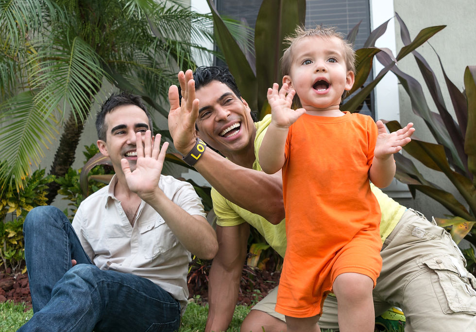 Two men waving and smiling at a child