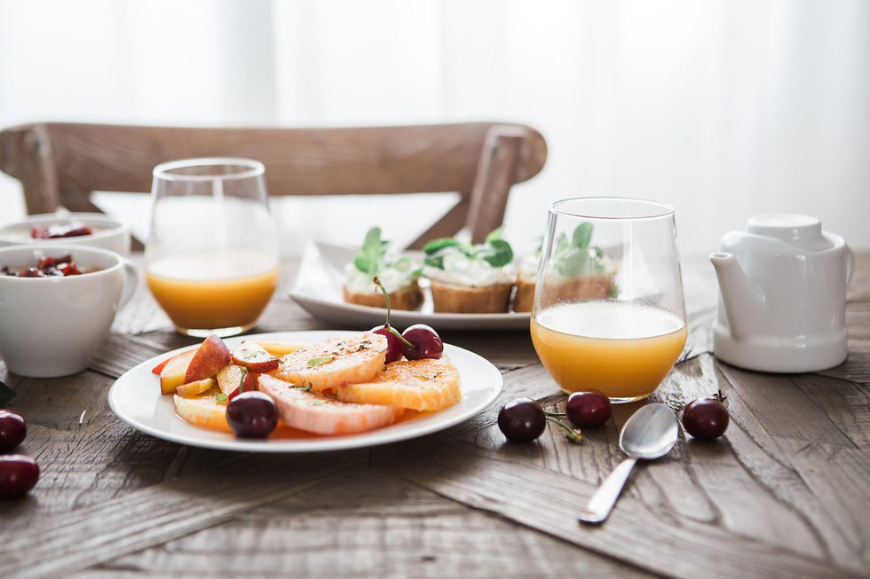 breakfast table milieu with a fruit salad and juice glasses