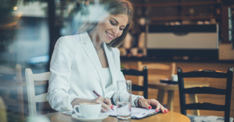 Woman working on paperwork in coffeeshop