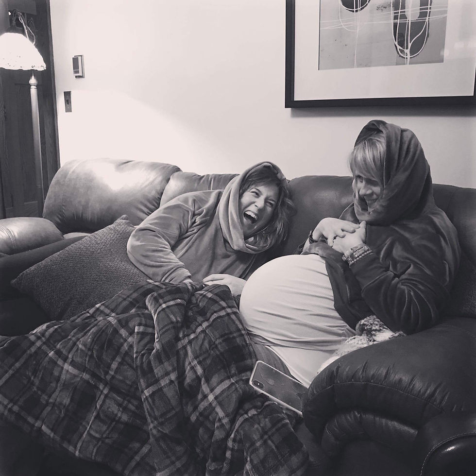 Expecting mother laughing with surrogate