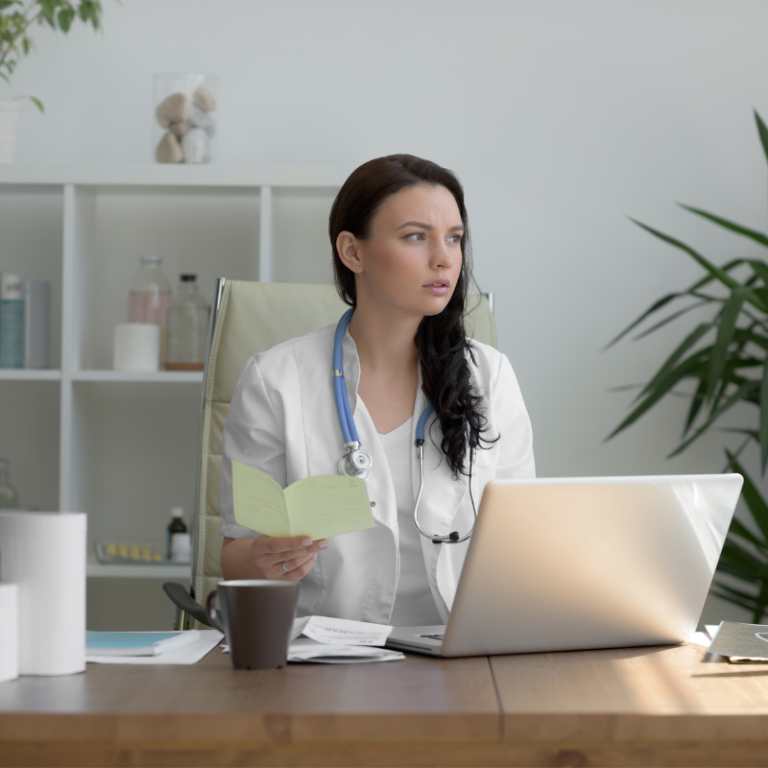 female doctor at desk looking concerned