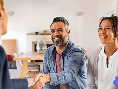 Smiling couple shakes hands with a surrogacy agency representative in a bright, modern office (models). Circle Surrogacy logo visible in the corner.