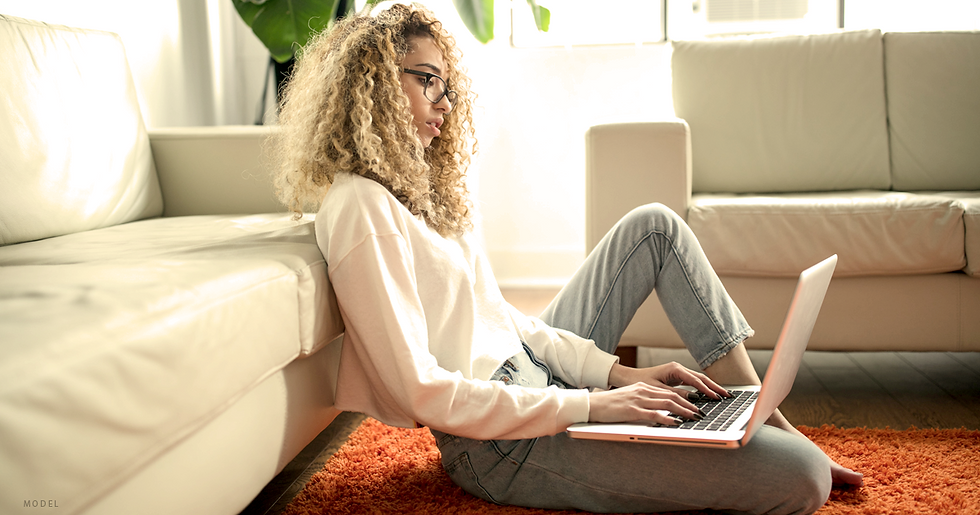 Young woman researching on laptop