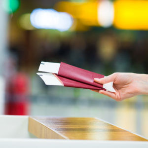 Close-up on airline tickets being held.