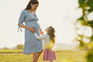 Mother and daughter in an open field
