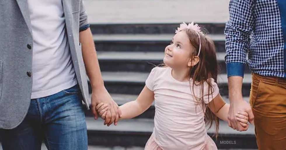 Parents walking hand in hand with their daughter (models)