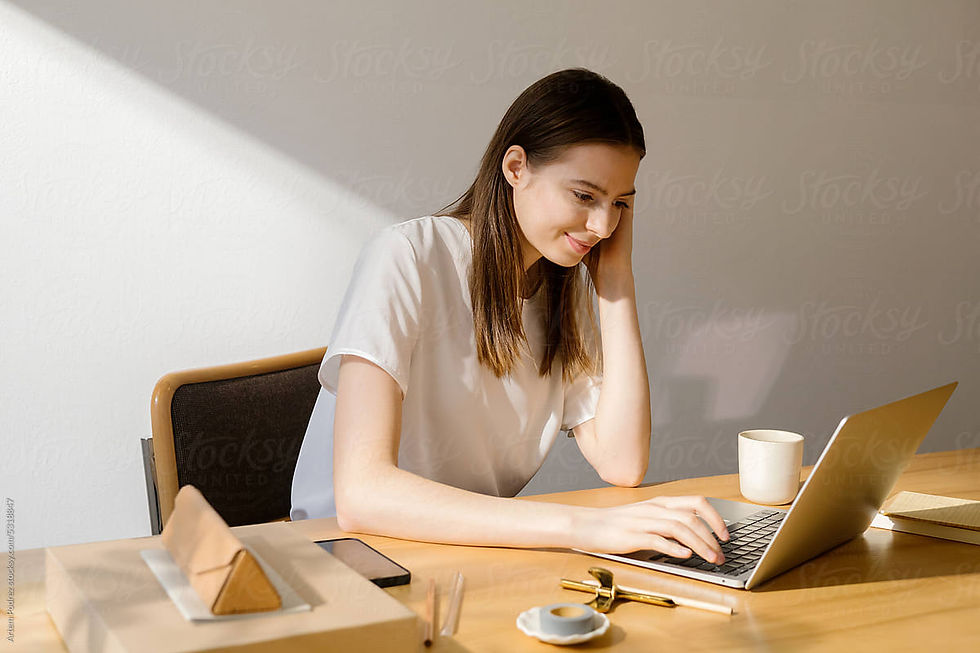 woman sitting on grass with laptop