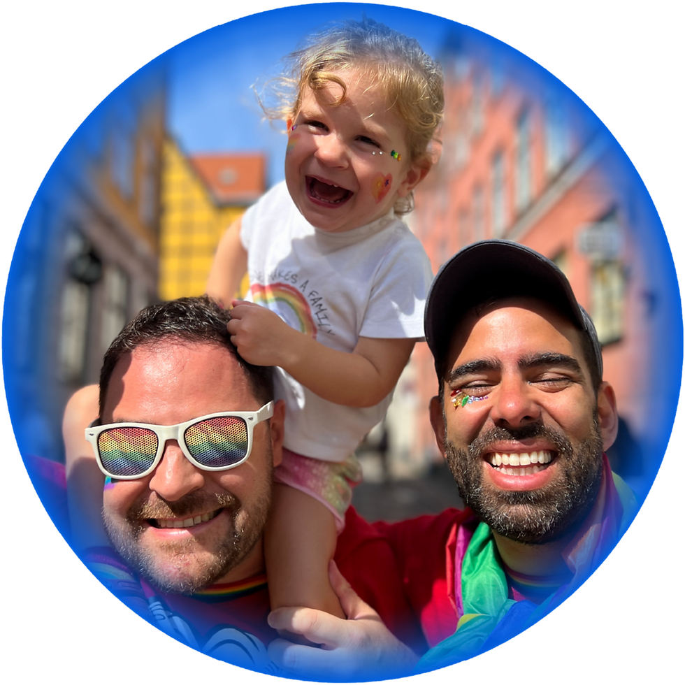 Happy toddler on dads' shoulders, rainbow family pride