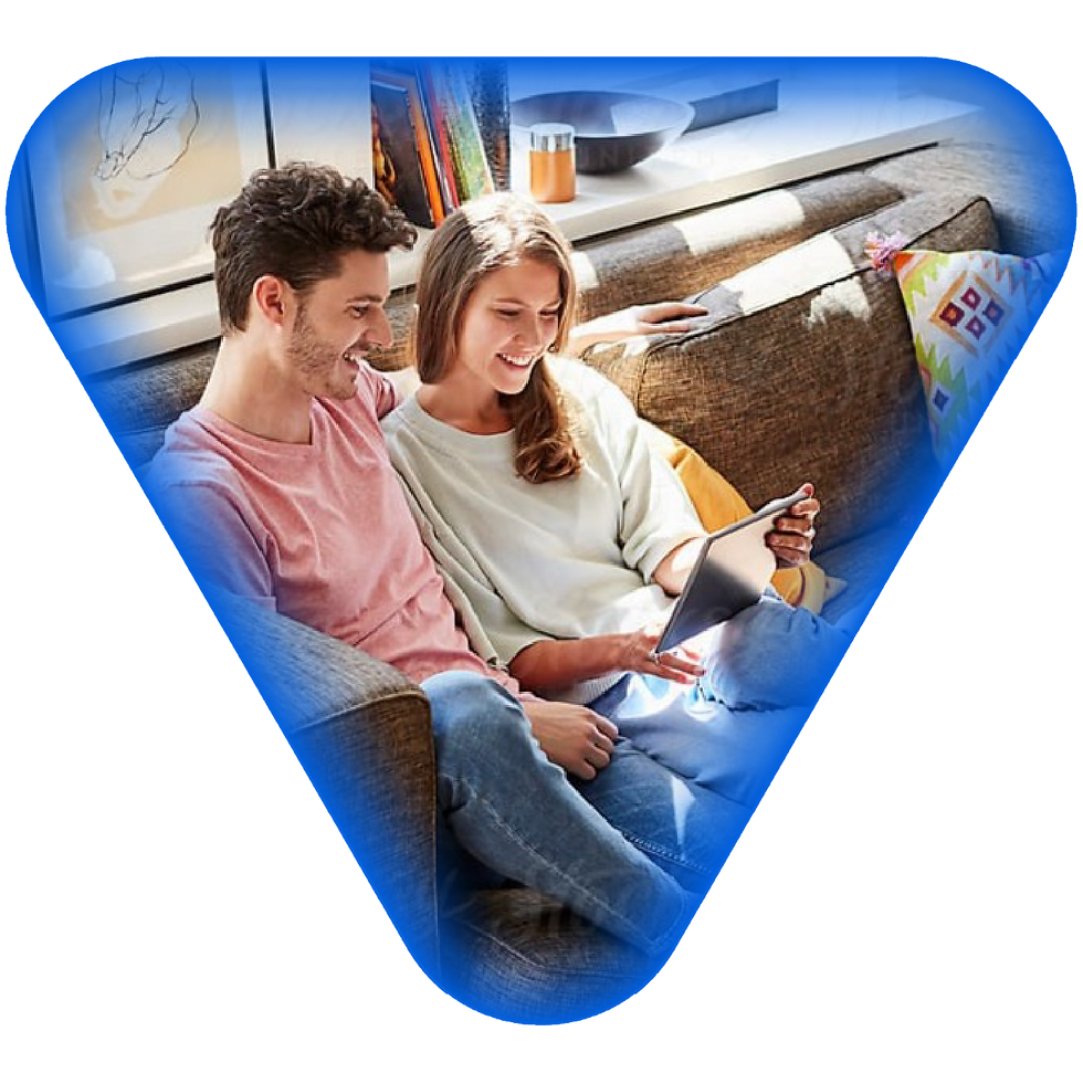 Couple relaxing on couch, using tablet