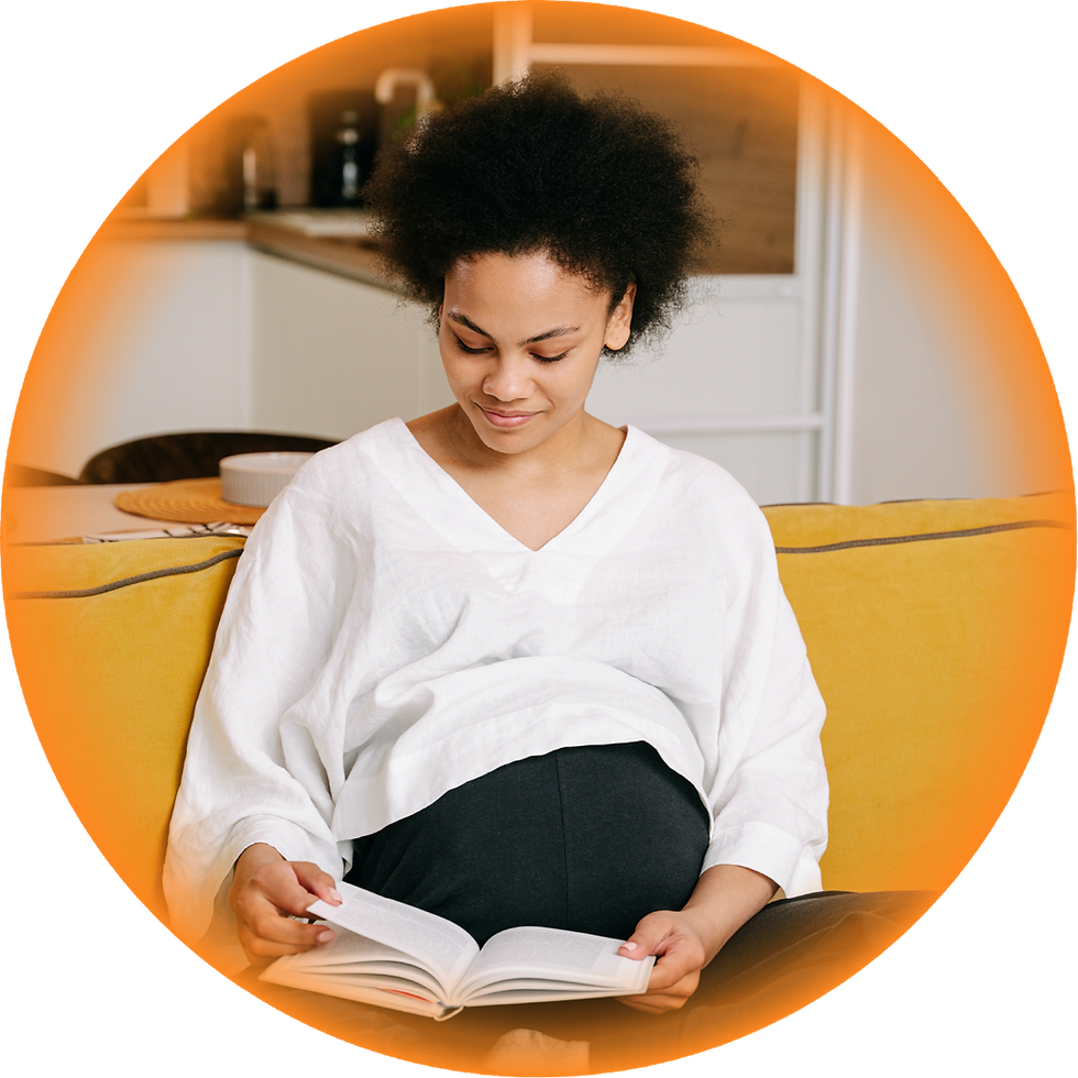 Pregnant woman reading book on couch