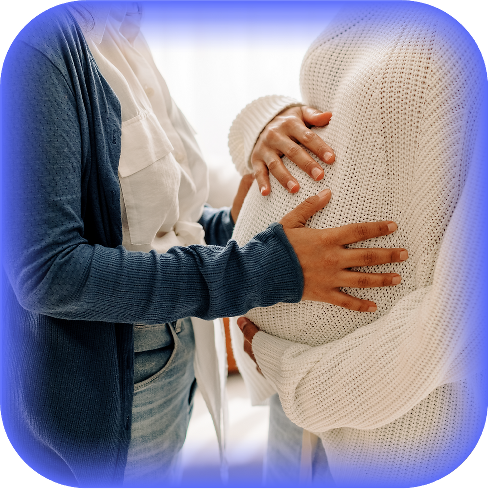 Two women gently touch a pregnant belly